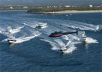 Helicopter with Boats in background over Broadwater